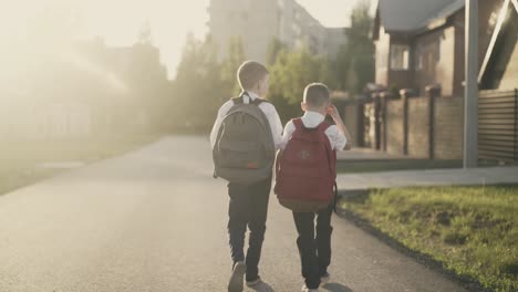 tracking two schoolchildren go home after school they talk