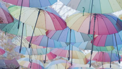 many colorful umbrellas hanging in the air