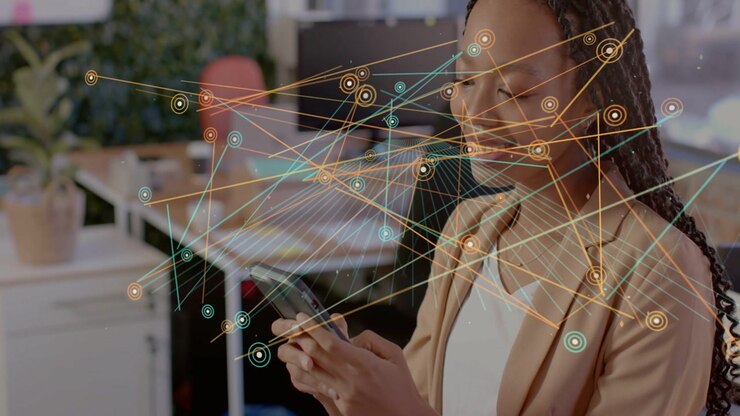 Woman tapping smartphone, activating tech nodes and lines over desk and woman to show connections