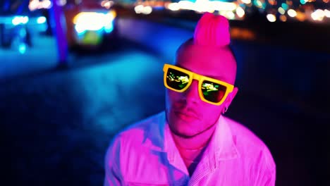 stylish man in neon pink mohawk at night