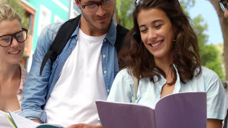 friends smiling while reading books