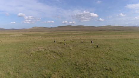 aerial view of ancient stone circle in a grassy field