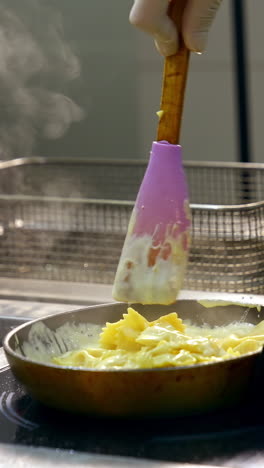 chef cooking pasta with sauce