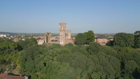 Castello-Scaligero-at-top-of-ridge-overlooking-Borghetto-Verona-Italy,-aerial-dolly