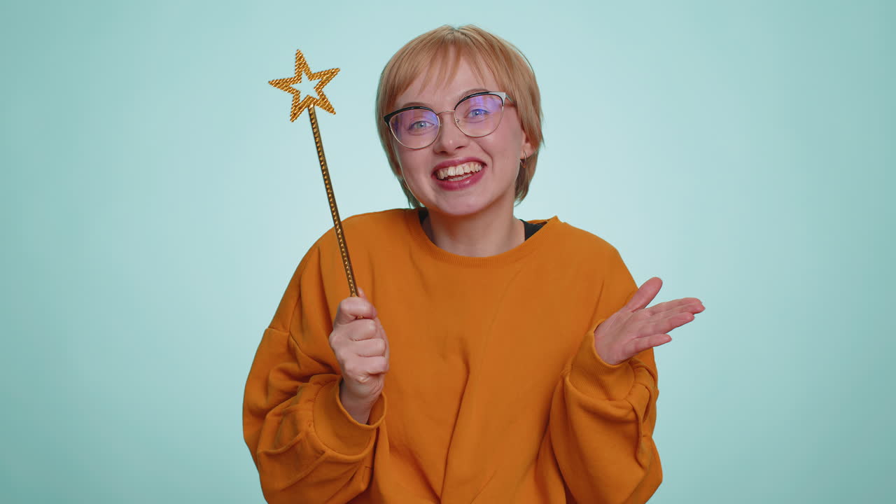 Magician witch young woman gesturing with magic wand making wish come true casting magician spell