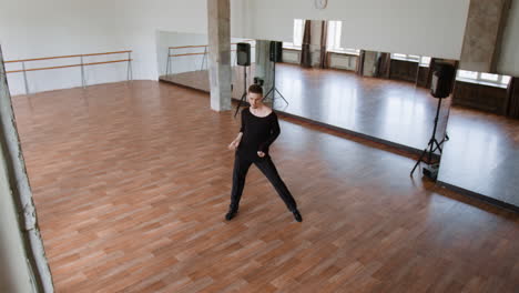 male dancer practicing in a spacious dance studio