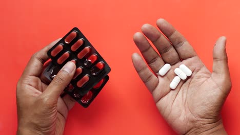 close up of man hand holding pills with copy space