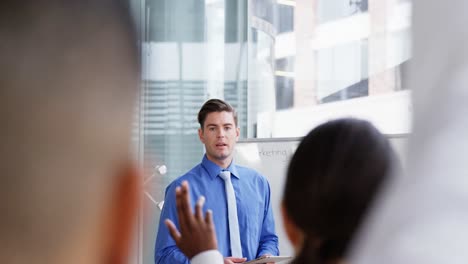 Businessman-giving-a-presentation-in-a-meeting