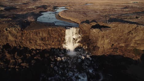 sunset stunning waterfall oxararfoss, dramatic rough volcanic landscape, aerial