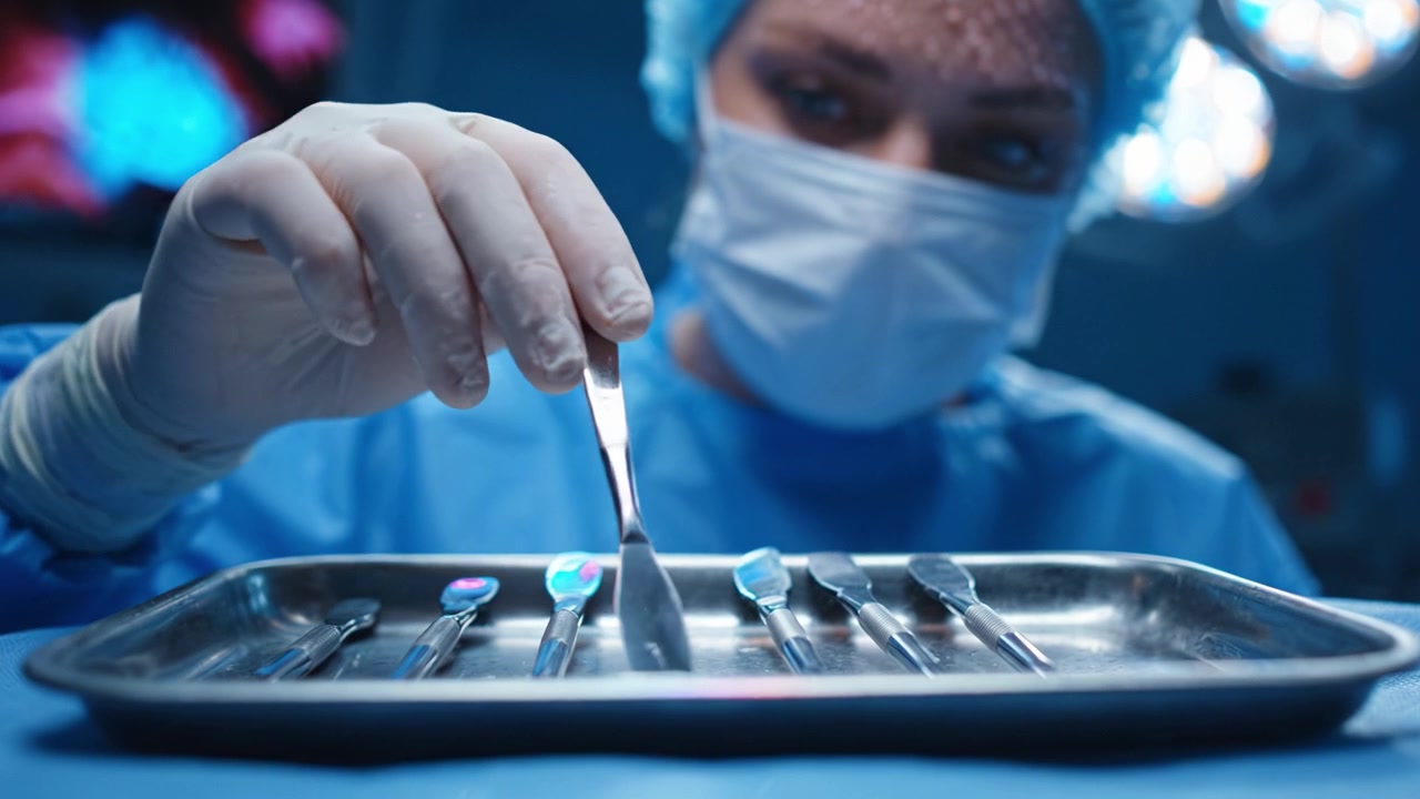 Focused Surgical Professional Preparing Instruments in a Sterile Environment for an Upcoming Procedure, Demonstrating Precision and Care Essential in Operations