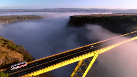 drone: bridge with mist and cars passing by