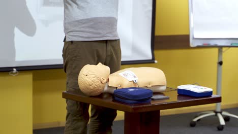 training for safe life of child. demonstrating chest compression on cardiopulmonary resuscitation baby doll