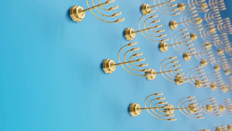 golden menorahs on a vibrant blue background vertical