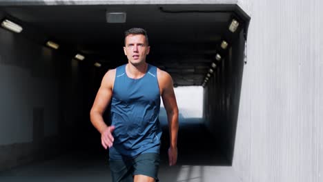 Young-Man-Running-Out-of-Tunnel.fitness,-sport-and-healthy-lifestyle-concept-young-man-running-out-of-tunnel