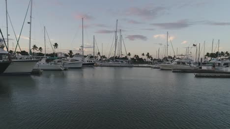 Aerial-pullback-sailing-boats-moored-on-marina-during-Sunset,-Hawaii