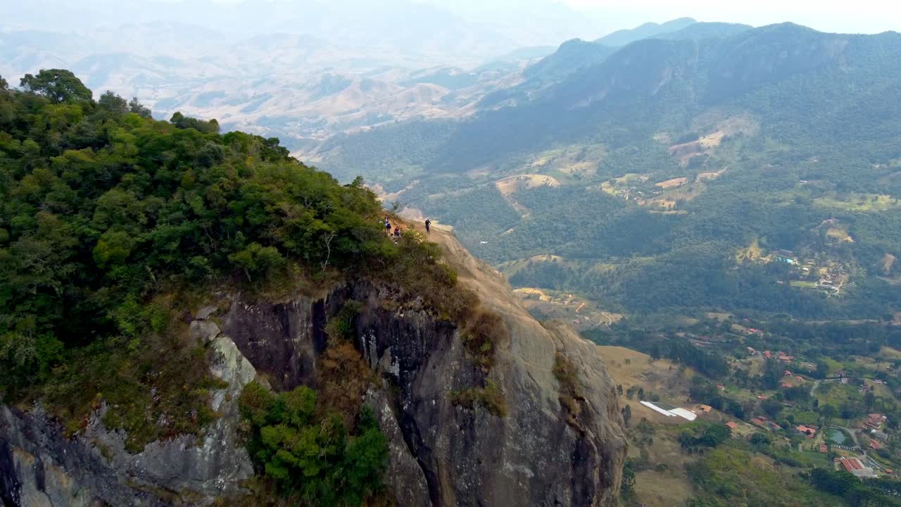 Fast dolly in over Rock Climbing Team on the summit of Pedra Do Bau in The Mantiqueira Mosaic in Brazil.