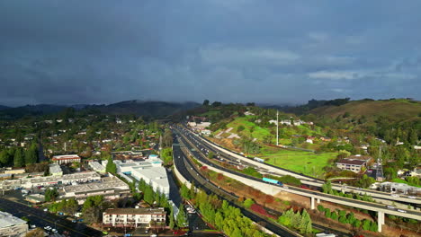 aerial view of a bustling expressway through verdant countryside landscape as vehicles commute