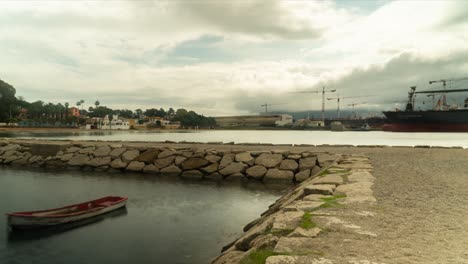 docked lonely wooden boat with dock building in background, time lapse