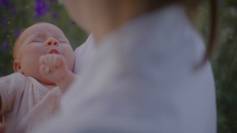 crying baby close-up in mother's arms