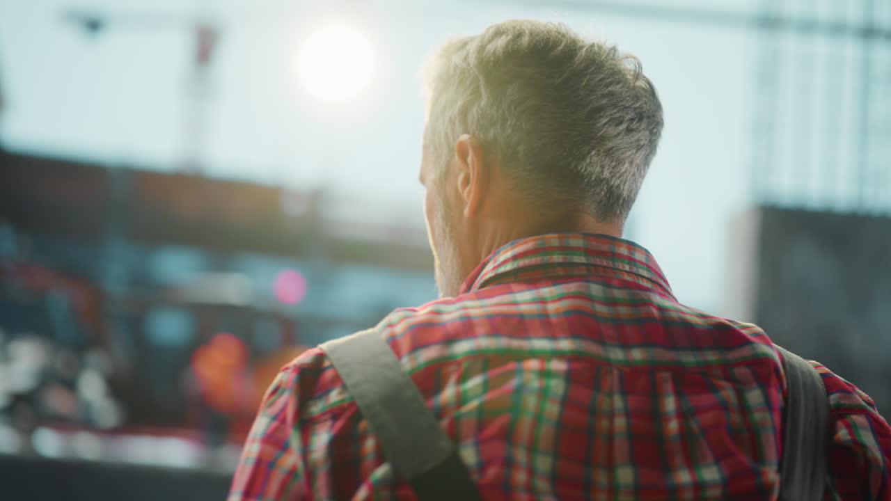 Rear View of a Worker at a Construction Site