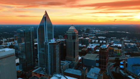 approaching the group of beautiful skyscrapers in the uptown of charlotte, nc, usa. splendid orange sky over the scenery of a city. top view
