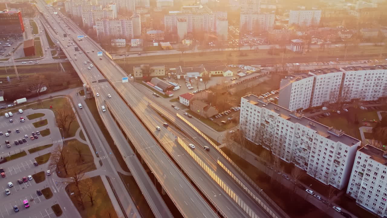 Busy traffic flow at slavu roundabout in riga, latvia during sunset, aerial view