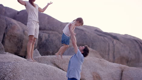 happy family playing on the beach at sunset on vacation