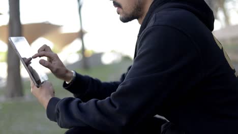 Cropped-shot-of-focused-man-using-tablet-pc