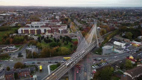 aerial panoramic view of luas train passing over dumdrum bridge in south dublin with dublin mountains in the background - ireland