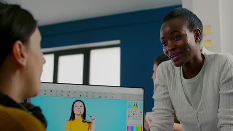 team of multiethnic retouchers working with modern photo editing software