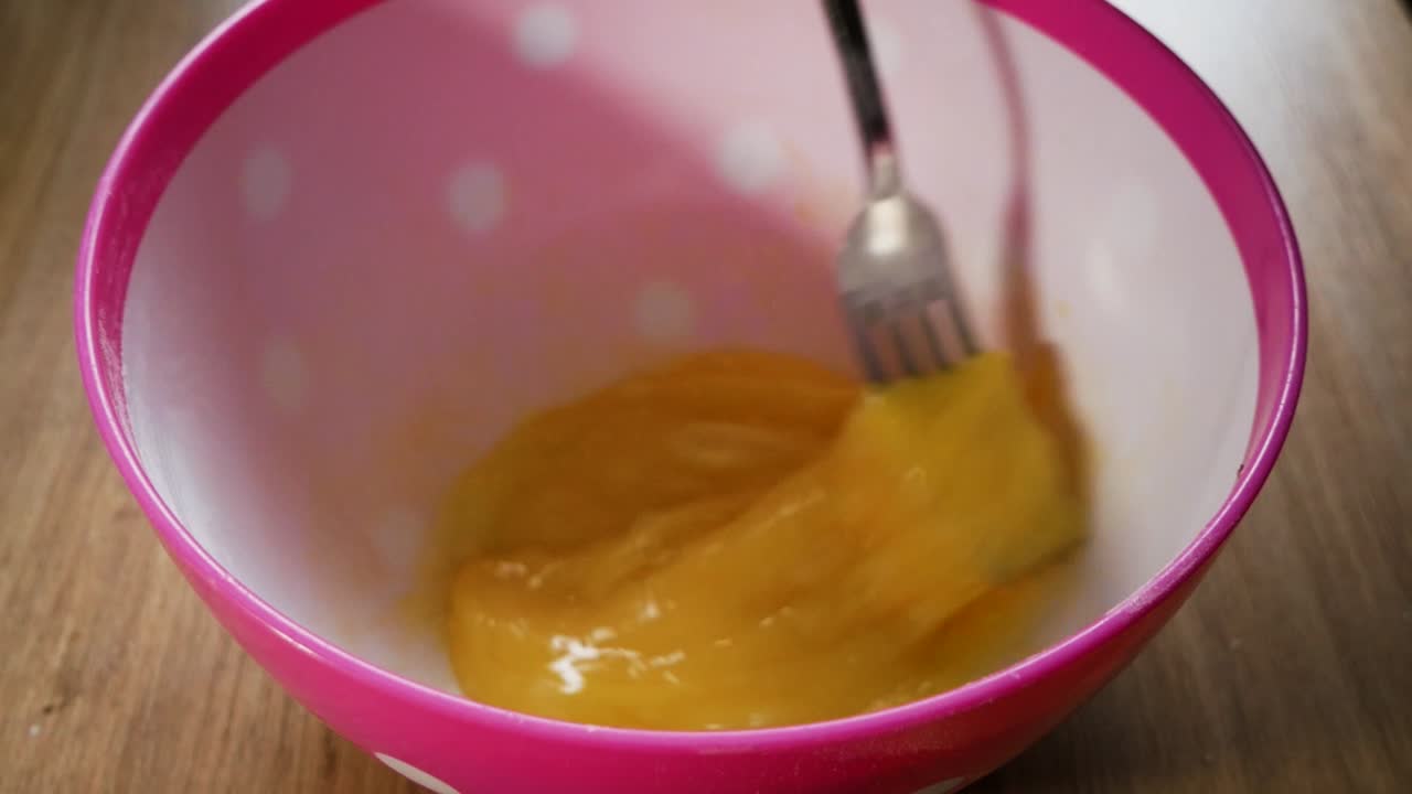 Whipping Egg Yolk for dough (batter) preparation. Homemade cooking,