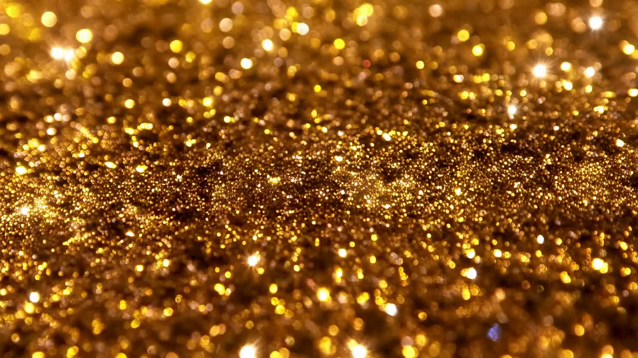 Makrolinse, der fokuserer på guldglitter på en bordplade, og afslører glimmer under varmt lys