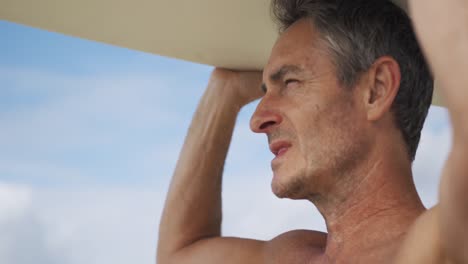 Man-on-beach-with-surfboard