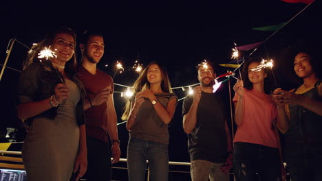 friends celebrate with sparklers at