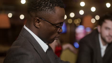 man looking at his opponents during poker match.