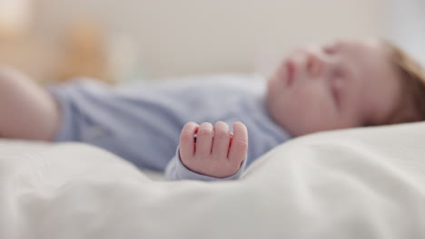 Hand,-baby-and-sleeping-on-bed-in-nursery