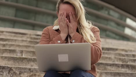 Overworked-blonde-mature-businesswoman-working-with-laptop