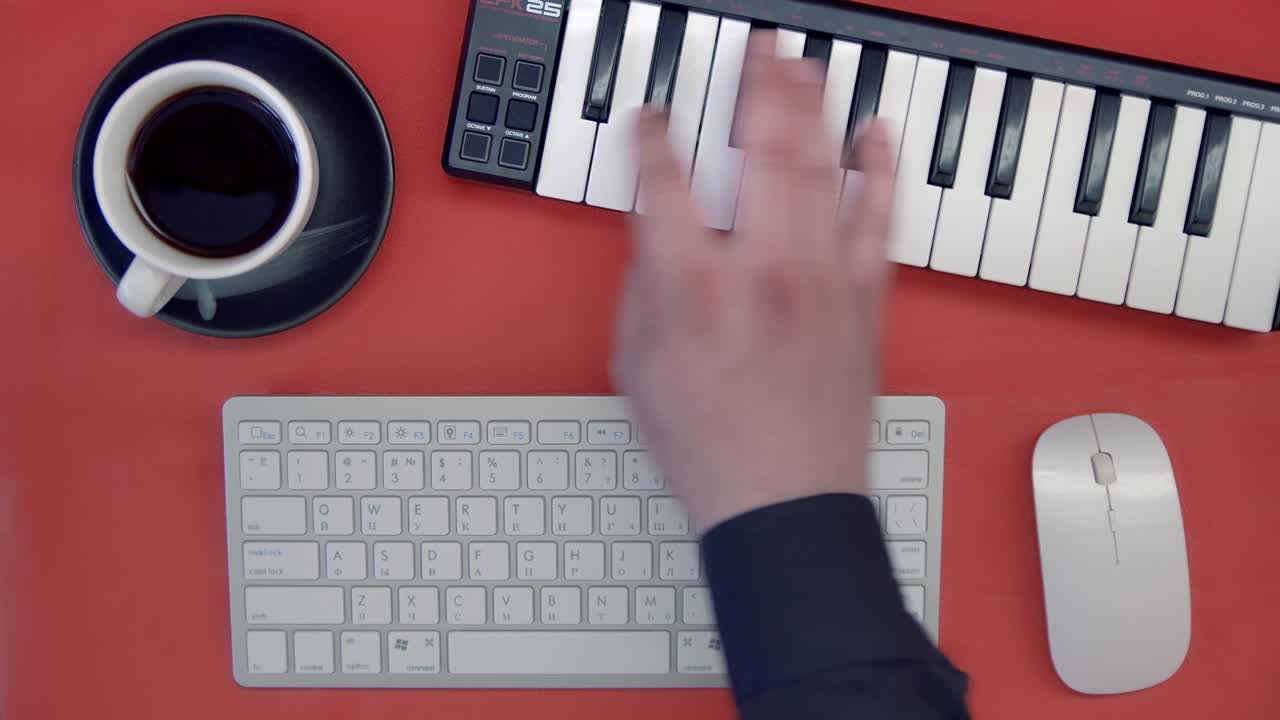 Man hand playing a MIDI controller keyboard synthesizer. DJ musician creates a new track. Top view. Minimalism