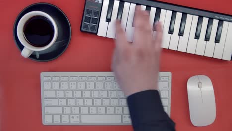 man hand playing a midi controller keyboard synthesizer. dj musician creates a new track. top view. minimalism