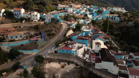 Blue-buildings-of-Juzcar-township,-aerial-hyperlapse