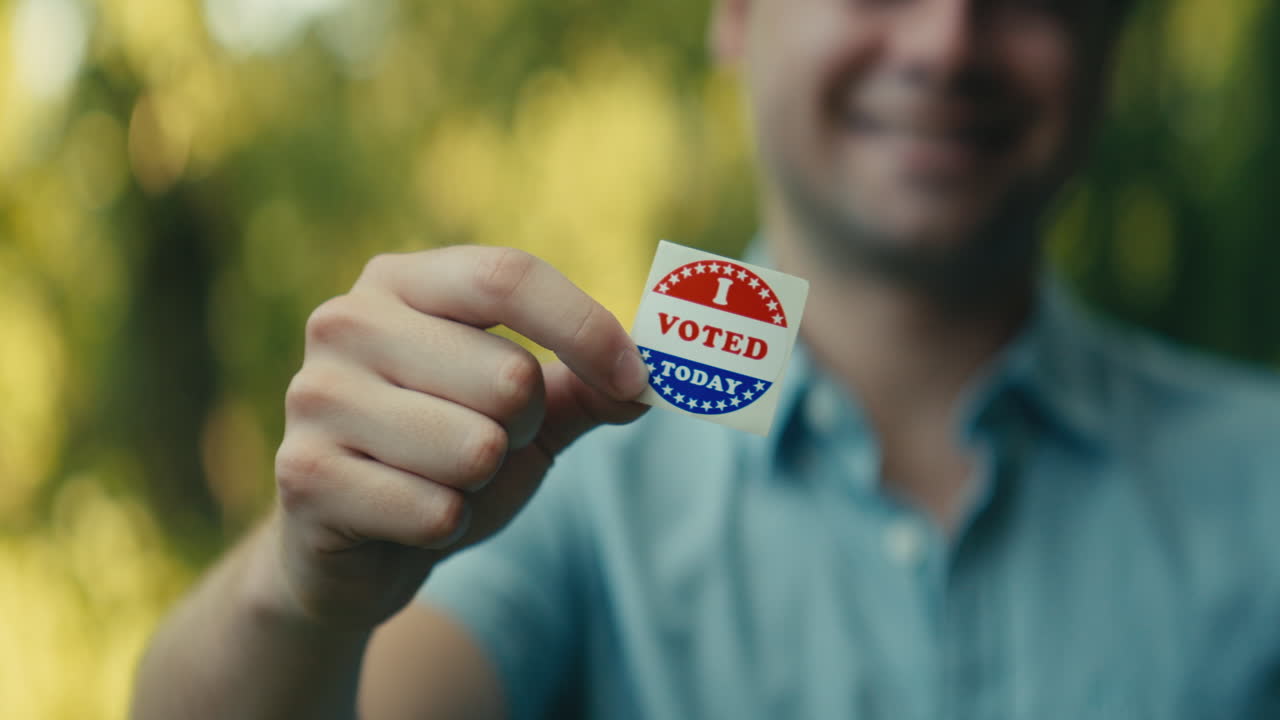 Man holding a Voted sticker