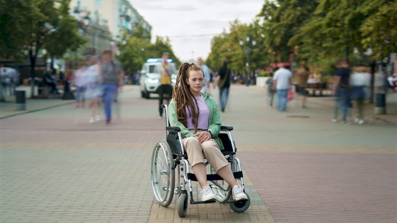 Woman in Wheelchair on City Street