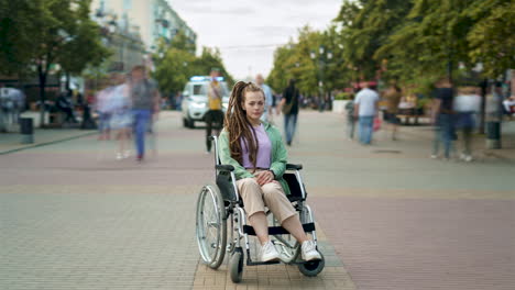 woman in wheelchair on city street