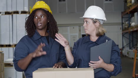 diverse female workers talking in warehouse