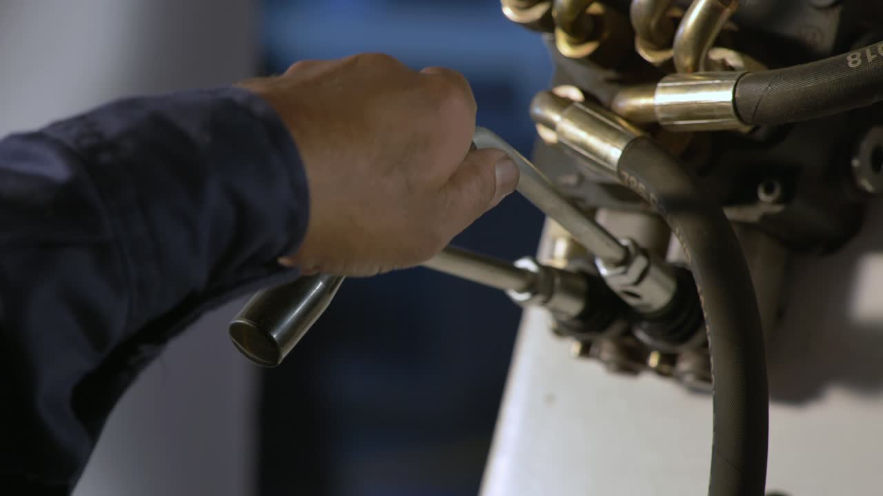 Industrial Operator Pulling Levers On A Machine During Manufacturing Production