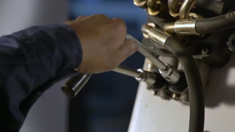 industrial operator pulling levers on a machine during manufacturing production