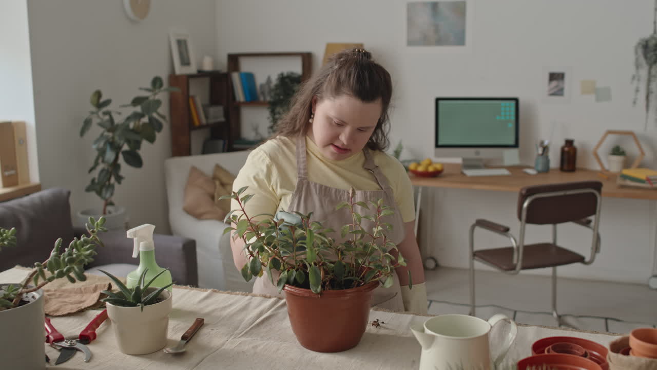 Woman with Down Syndrome Gardening Indoors