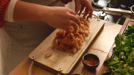 woman cutting chicken for dinner