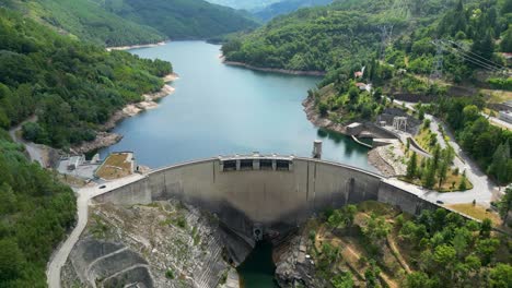 Dam-aerial-shot-in-northern-Portugal,-Salamonde,-Montalegre,-Portugal,-aerial-shot-on-a-sunny-day-geres-national-park,-Zoom-out