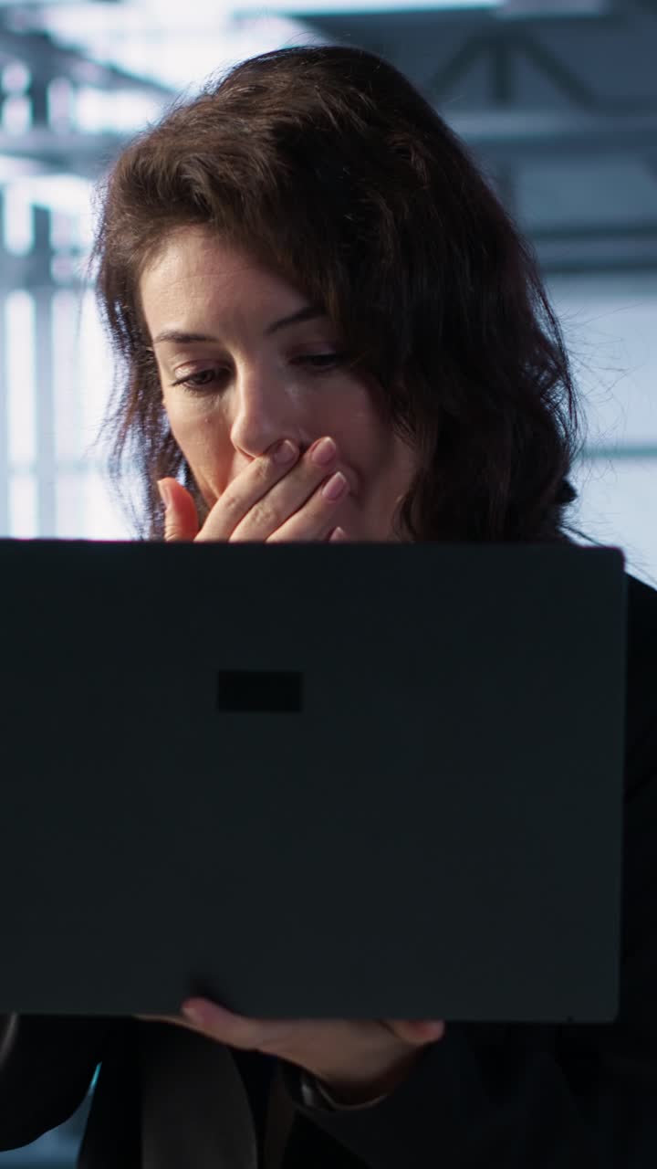 Vertical video Server room worker under pressure to secure sensitive data after threat alert